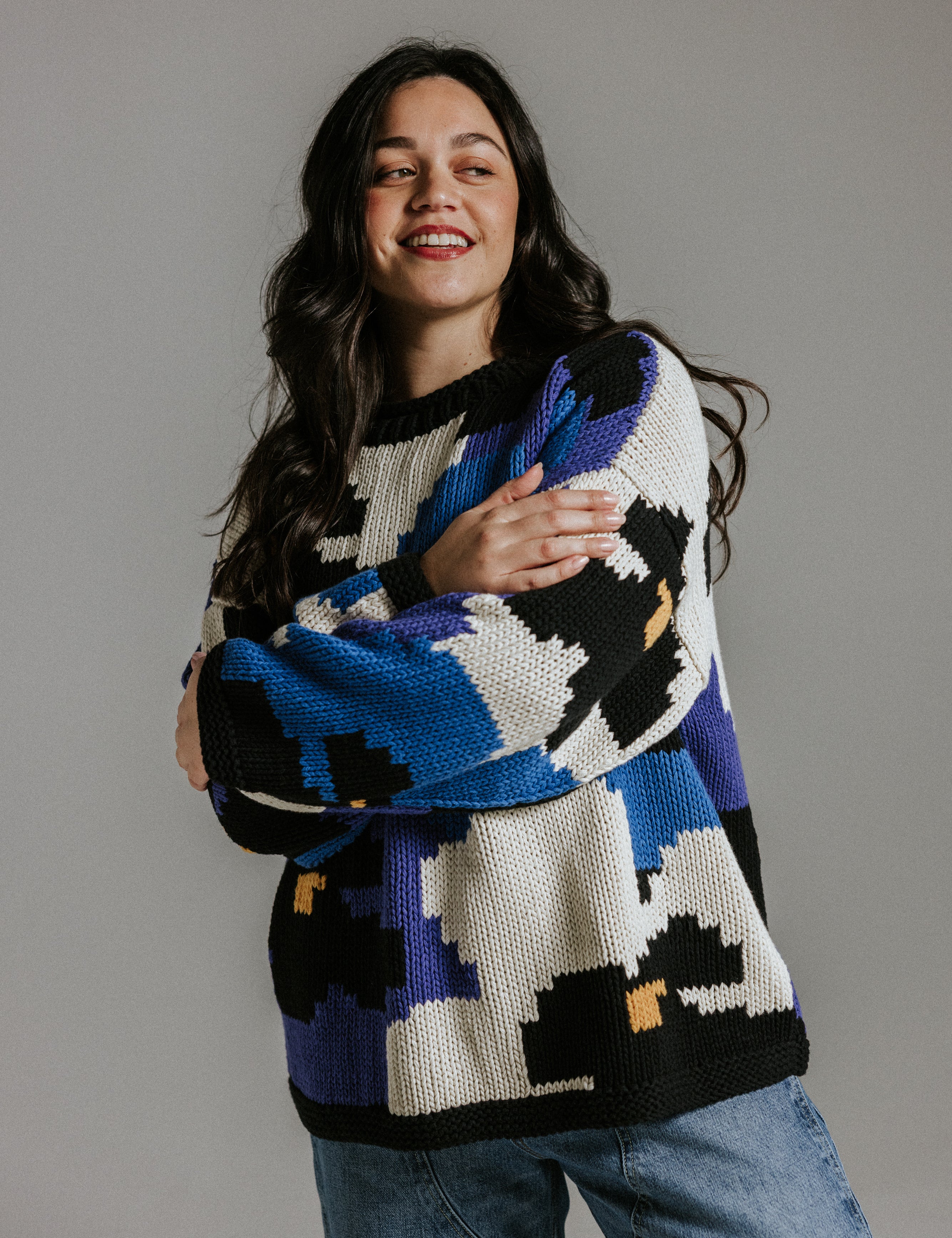 Hand knitted cotton jumper by Slow Love Knitwear with five colour floral intarsia pattern