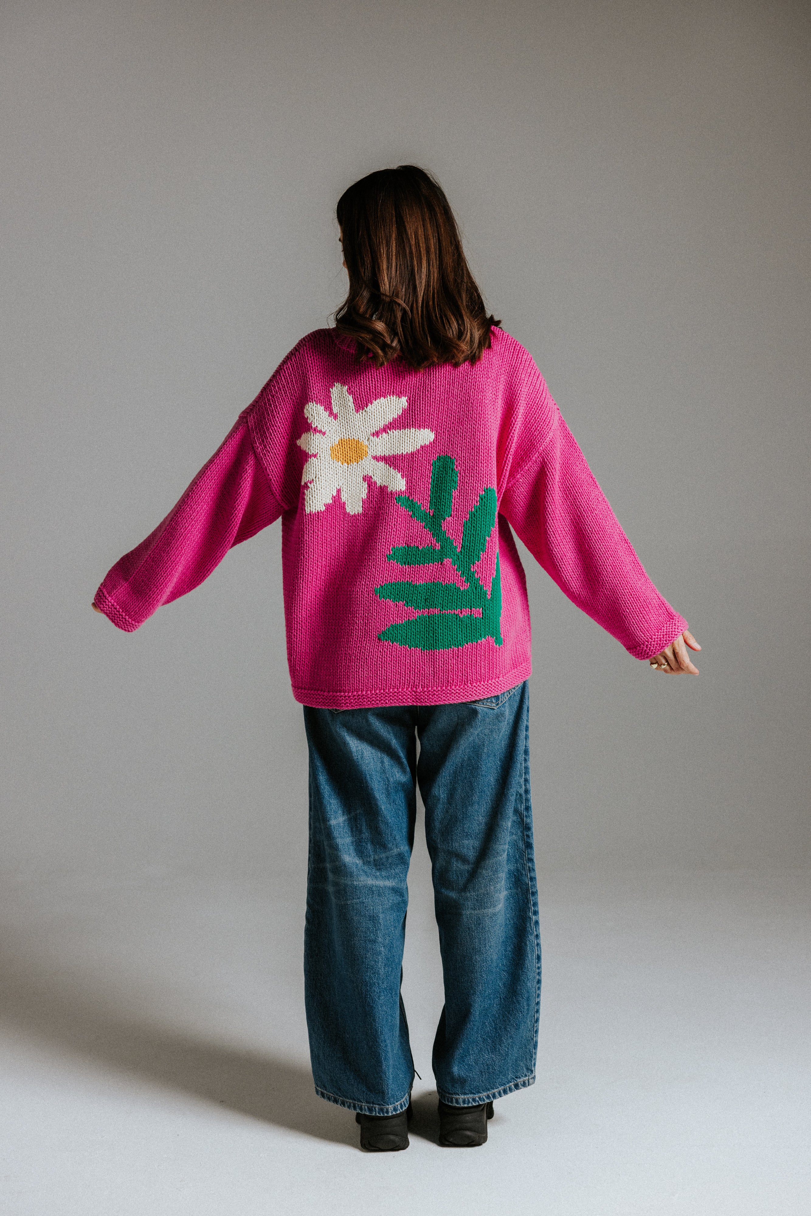 Back view of hand knitted cotton jumper with daisy intarsia motif by Slow Love Knitwear