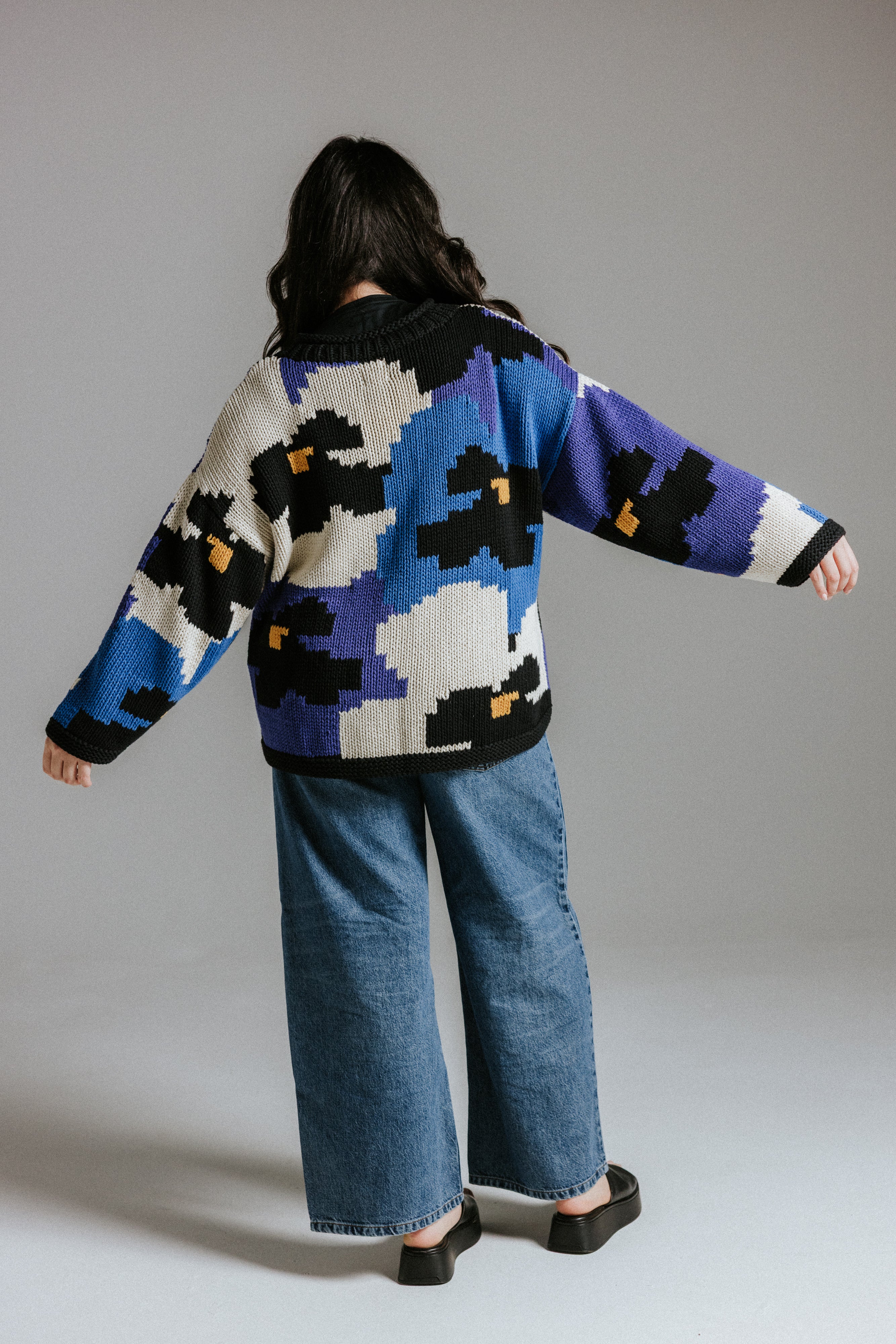 Back view of hand knitted cotton jumper with floral intarsia design by Slow Love Knitwear