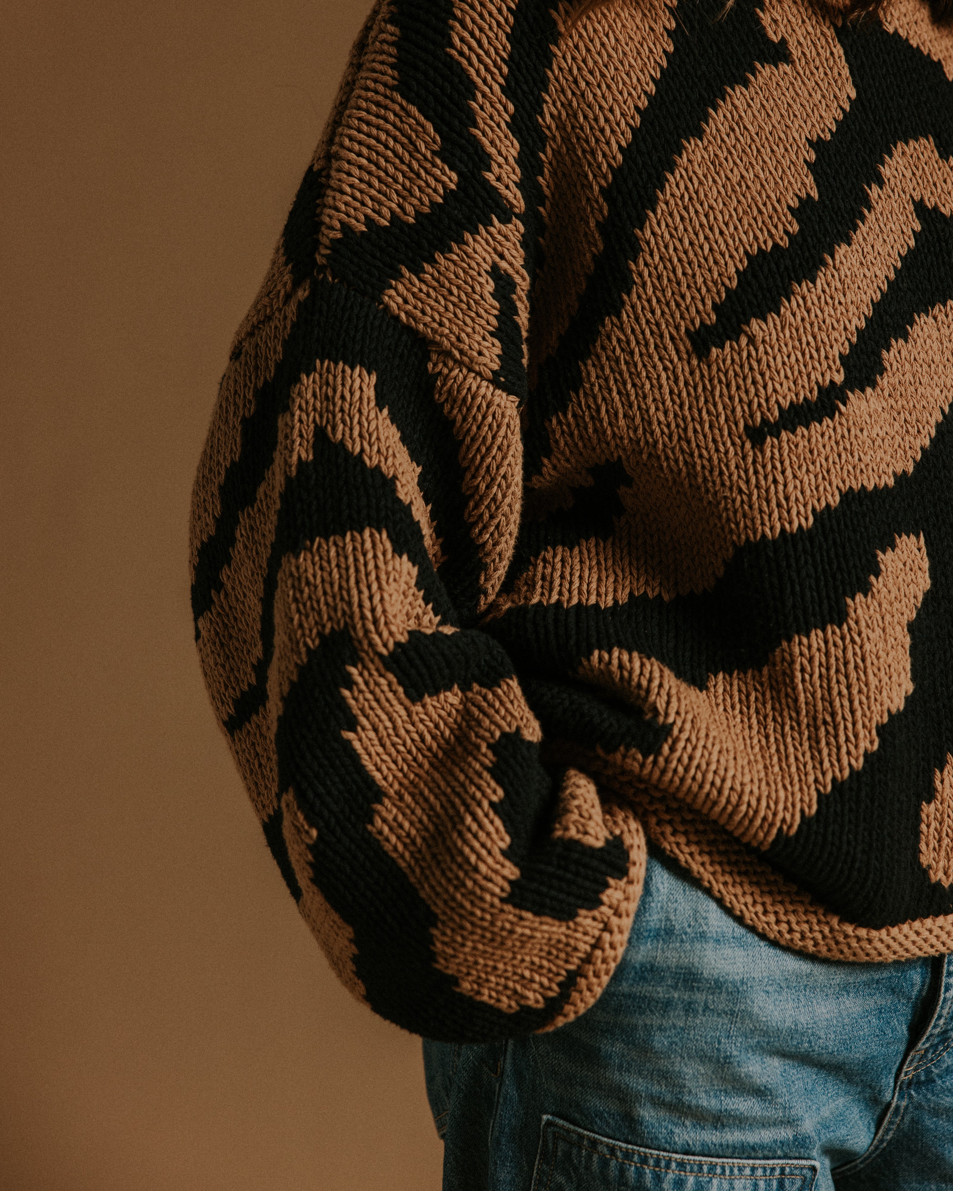 Close up of two colour intarsia tiger pattern on hand knitted cotton jumper by Slow Love Knitwear