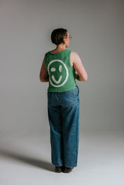 Back view of green and white cotton knit tank top by Slow Love Knitwear with smiley face design
