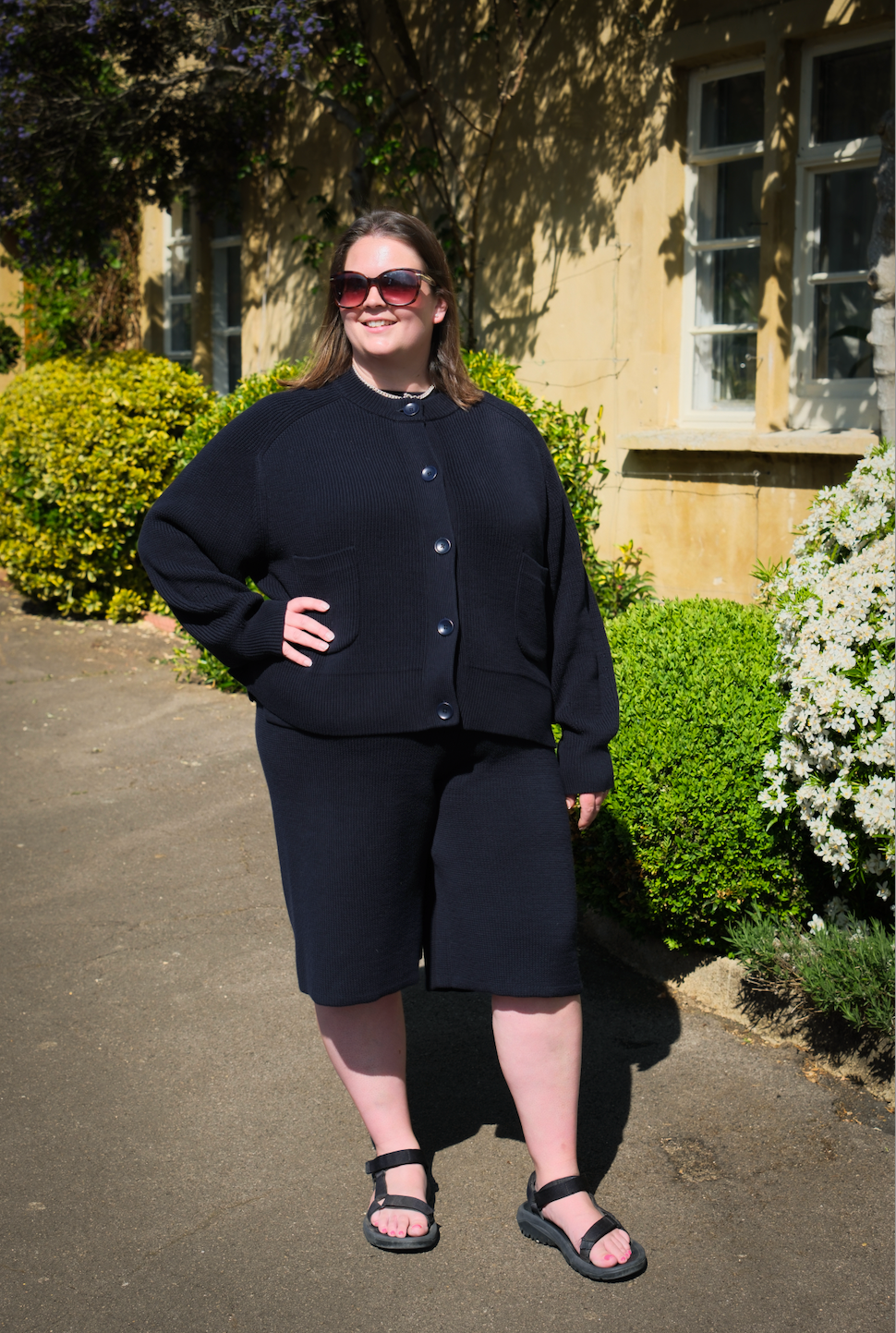 Midnight navy knitted shorts by Slow Love featuring a subtle flared leg and a chic, relaxed fit.