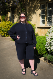Midnight navy knitted shorts by Slow Love featuring a subtle flared leg and a chic, relaxed fit.