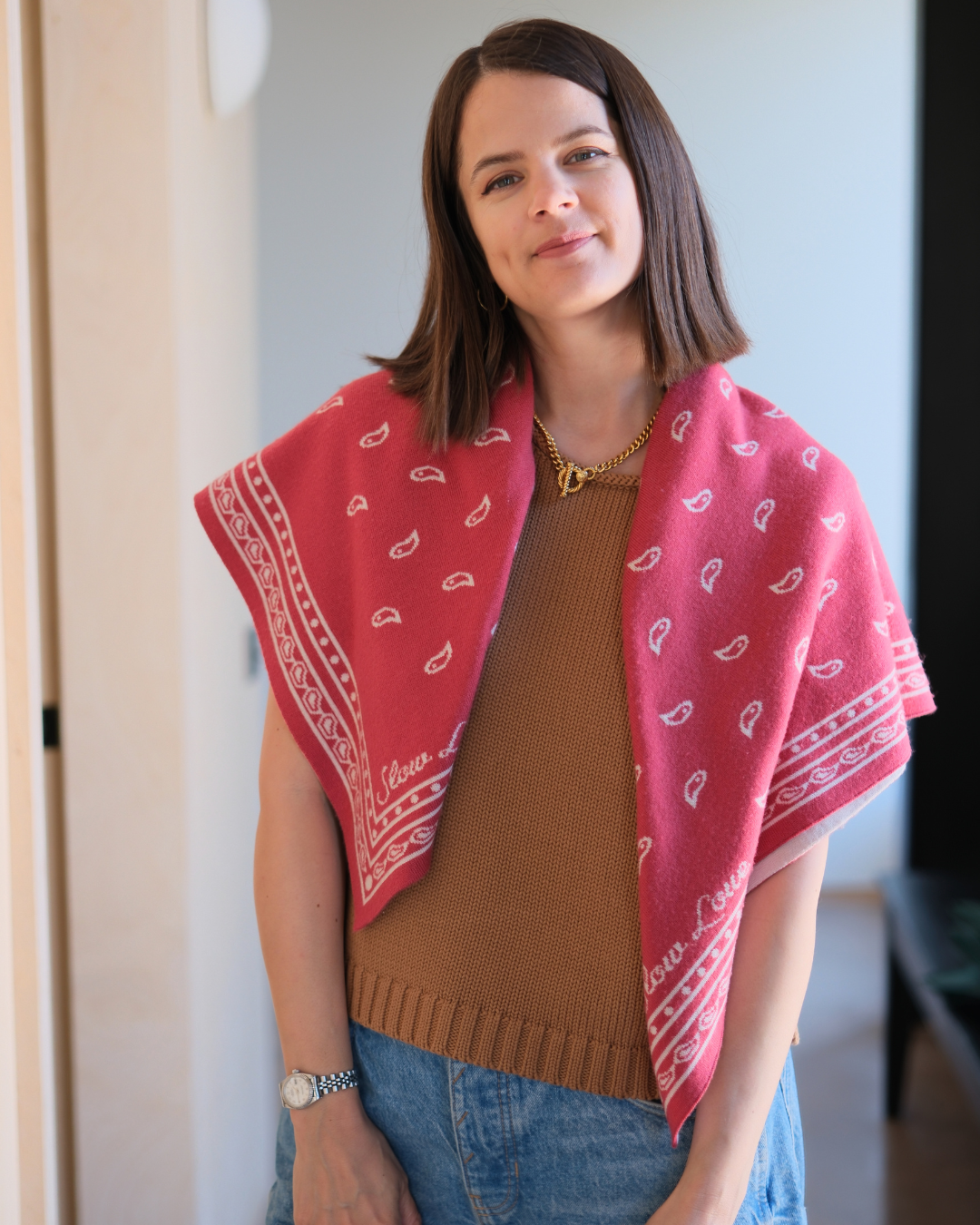 Close-up of the red Bandana Scarf by Slow Love Knitwear, showcasing its soft merino wool knit and rich red colour.