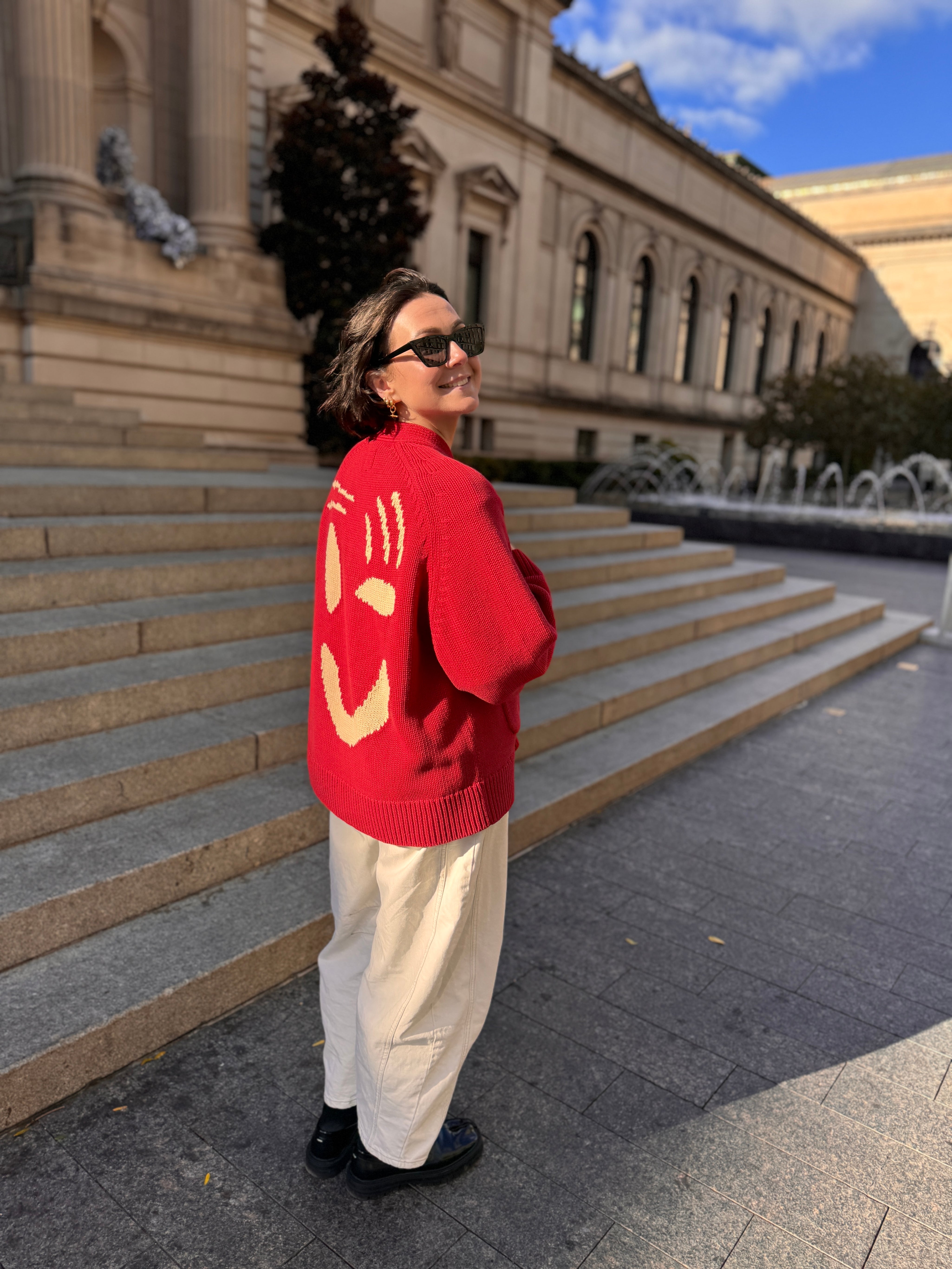 The Slow Love Feel Good Cardigan in red, featuring an oversized fit and relaxed grandad-style silhouette.