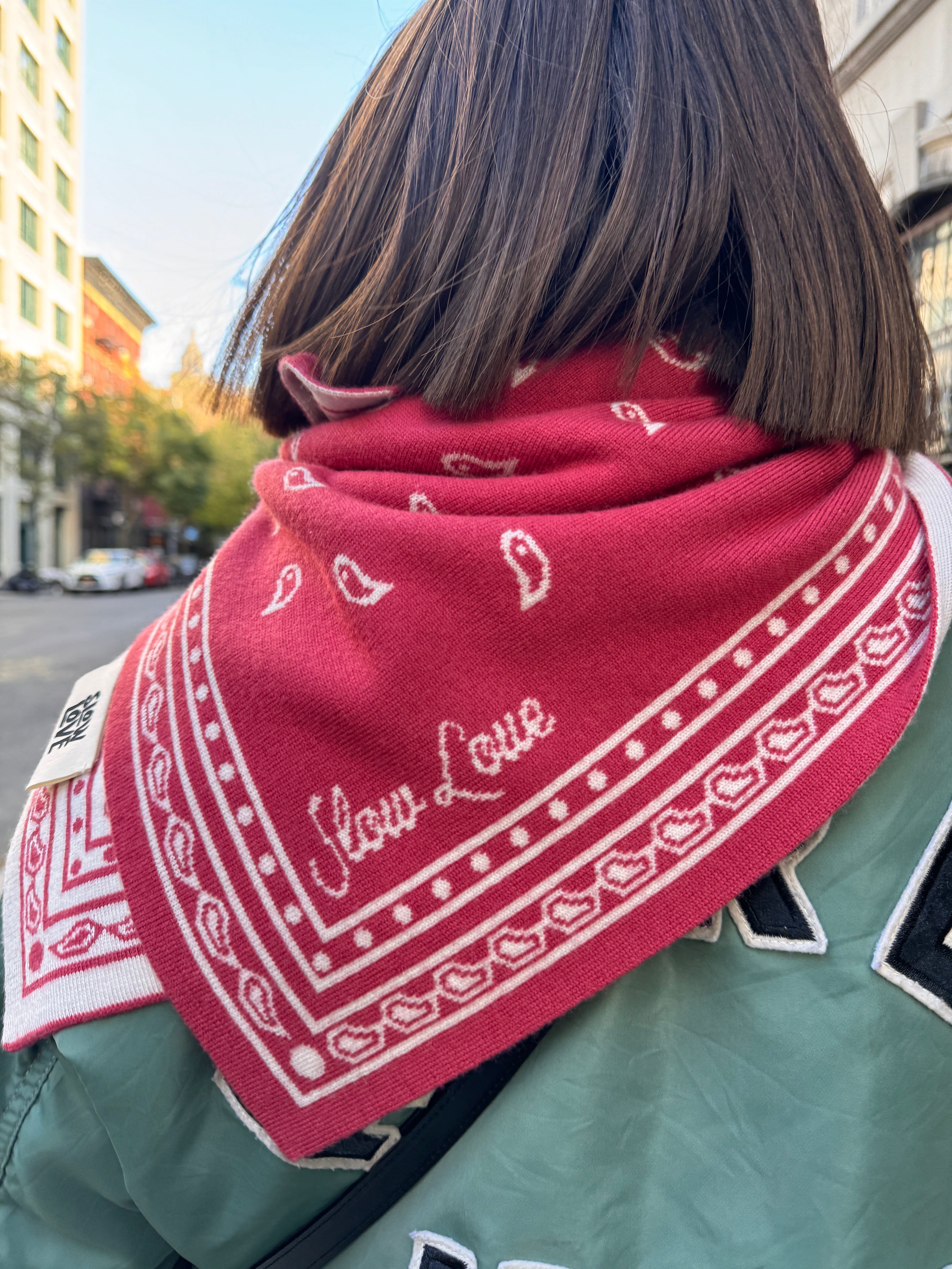 Red merino wool bandana scarf by Slow Love Knitwear, a soft knitted accessory for adding warmth and colour to everyday outfits.