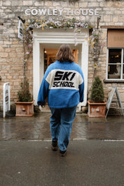 Back of the Slow Love Ski School Jumper, highlighting its chunky 100% cotton knit and distinctive ski-inspired design.