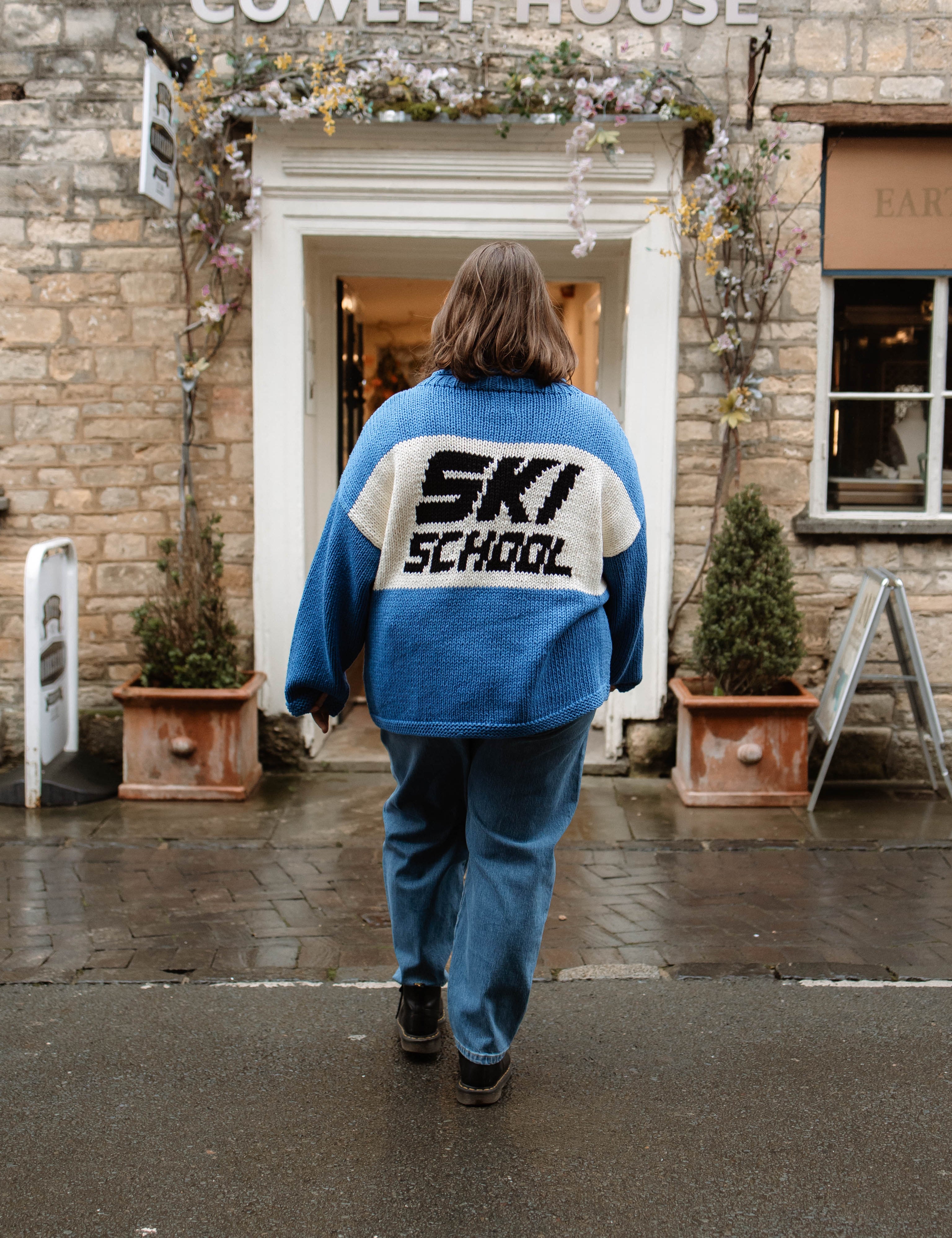 Back of the Slow Love Ski School Jumper, highlighting its chunky 100% cotton knit and distinctive ski-inspired design.