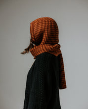 Close-up of The Slow Love Fisherman Striped Wool Hood in toffee and brown, showcasing its striped knit design and soft merino wool texture.