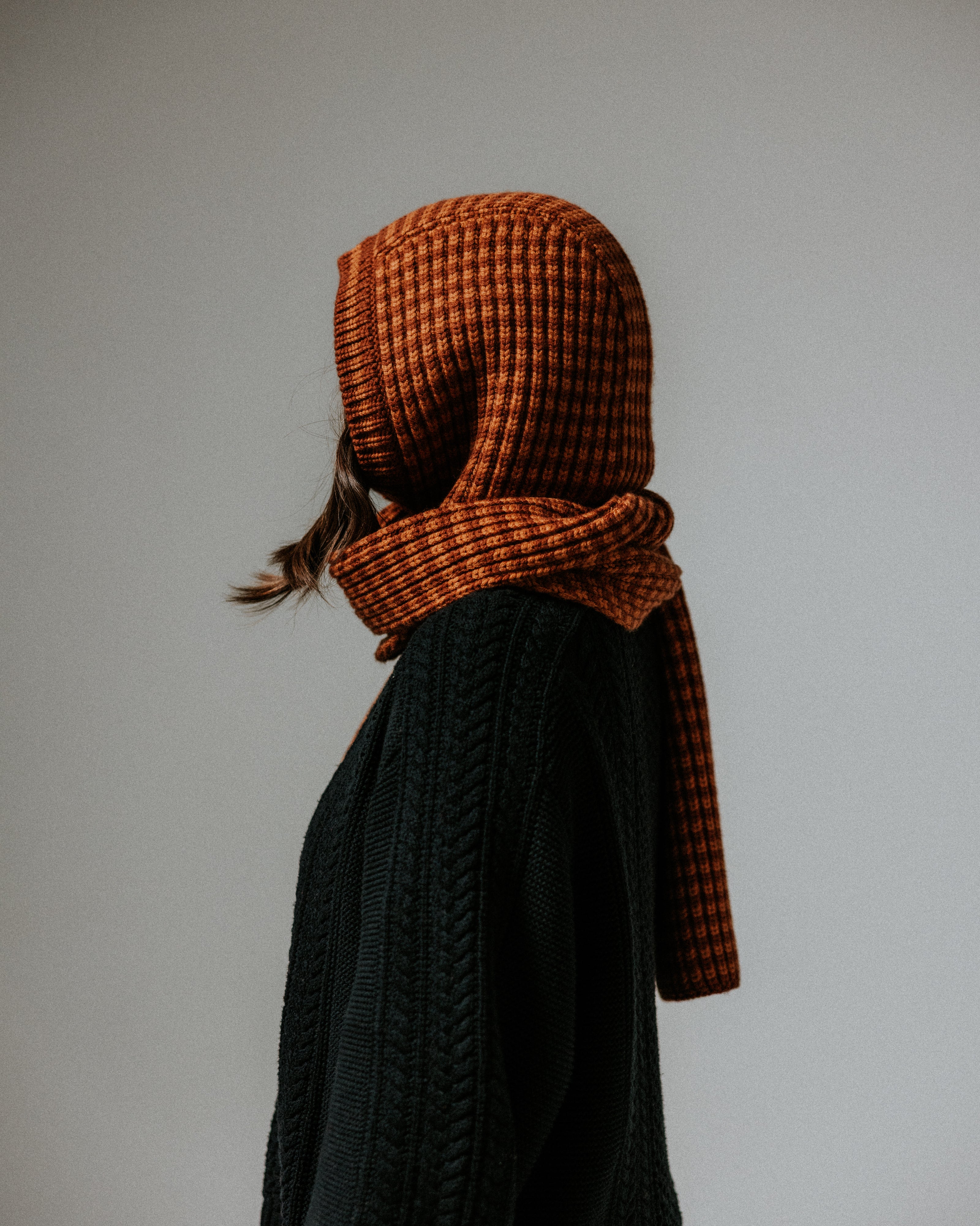 Close-up of The Slow Love Fisherman Striped Wool Hood in toffee and brown, showcasing its striped knit design and soft merino wool texture.