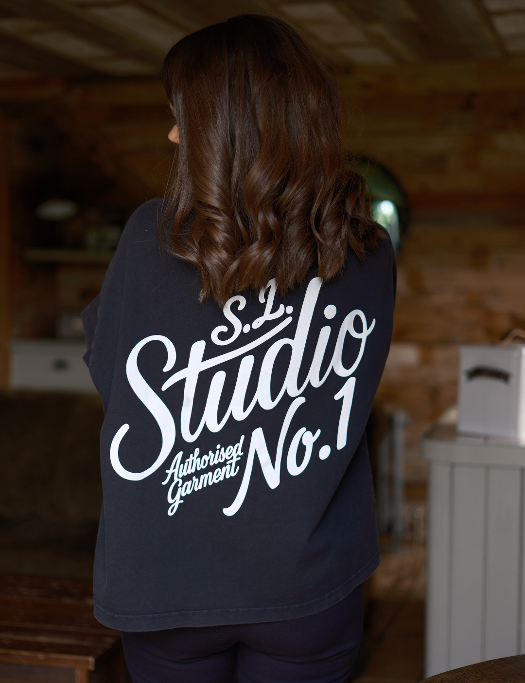 Back view of Slow Love Studio oversized faded black organic cotton t-shirt.