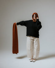The Slow Love toffee and brown striped merino wool hood, a cosy knitted accessory made from 100% premium merino wool.