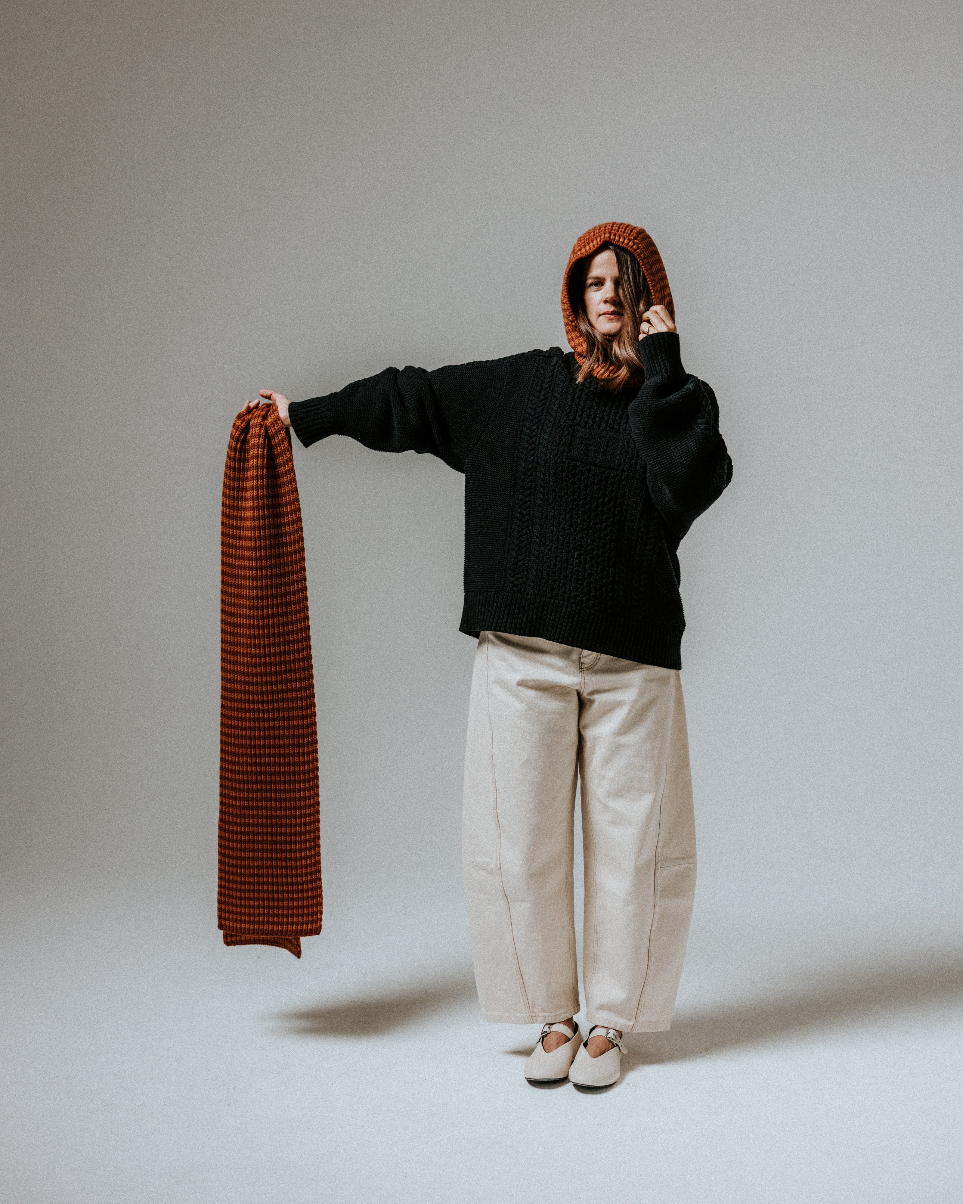 The Slow Love toffee and brown striped merino wool hood, a cosy knitted accessory made from 100% premium merino wool.
