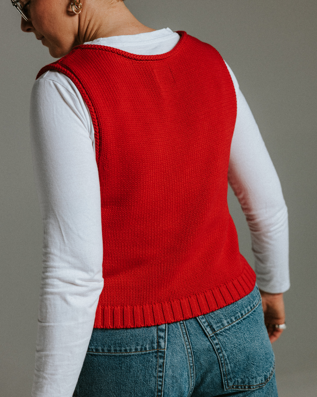 Model wearing red cotton knit tank top, relaxed summer layering piece