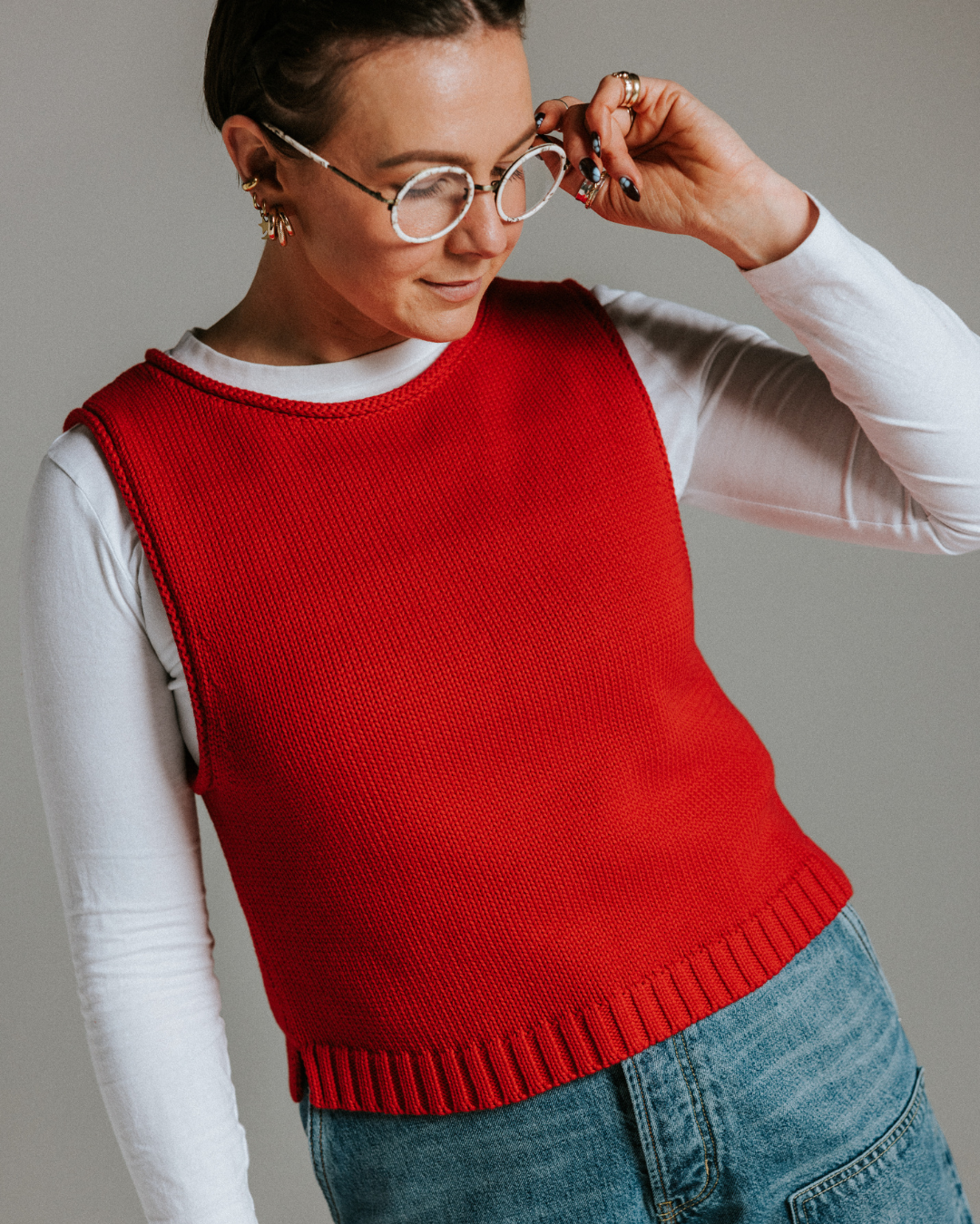 Model wearing red cotton knit tank top, relaxed summer layering piece