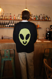 Close-up of alien motif on hand knit jumper showing knit detail