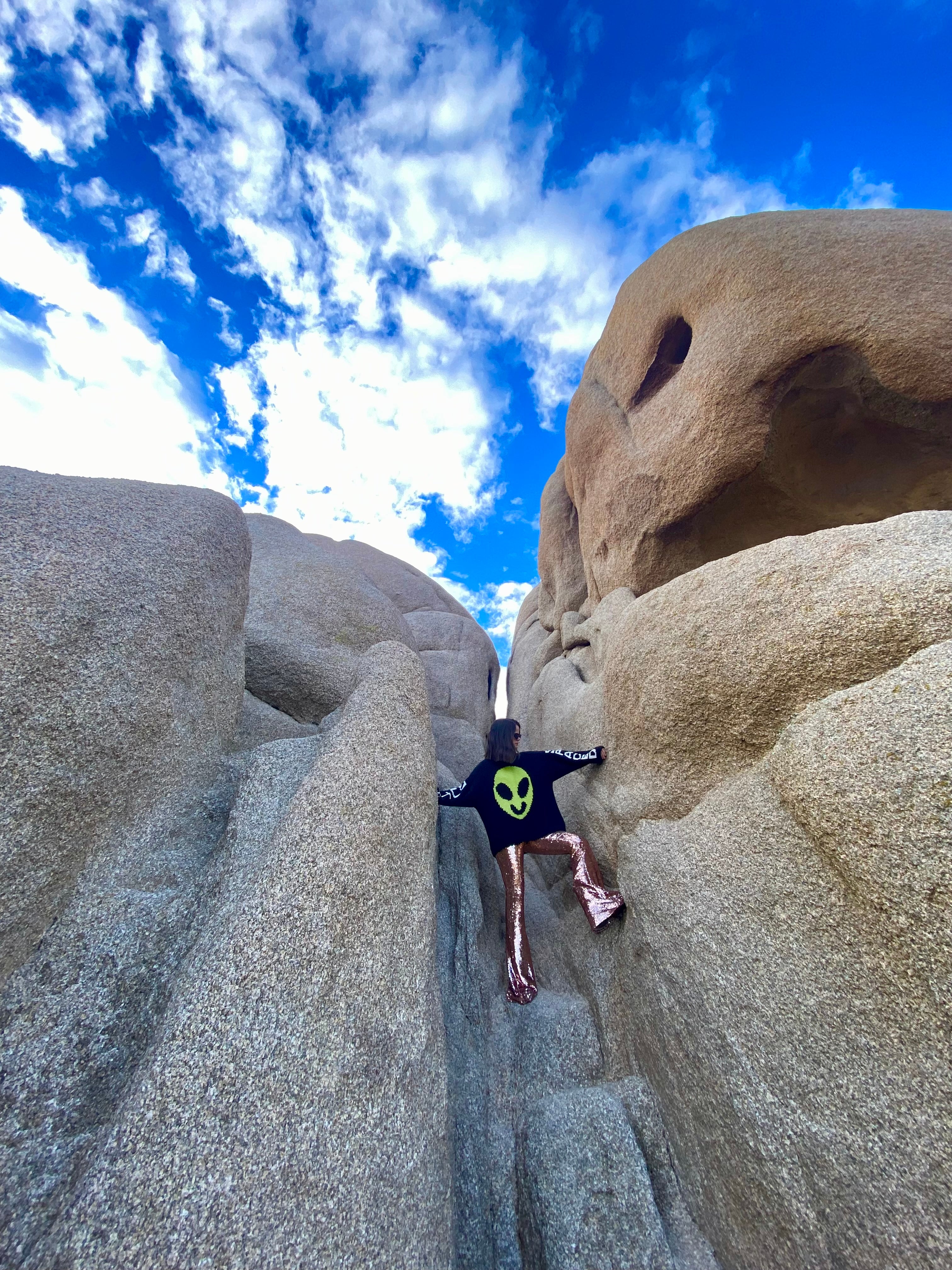 Model wearing Spaced Out jumper in motion showing drape and movement