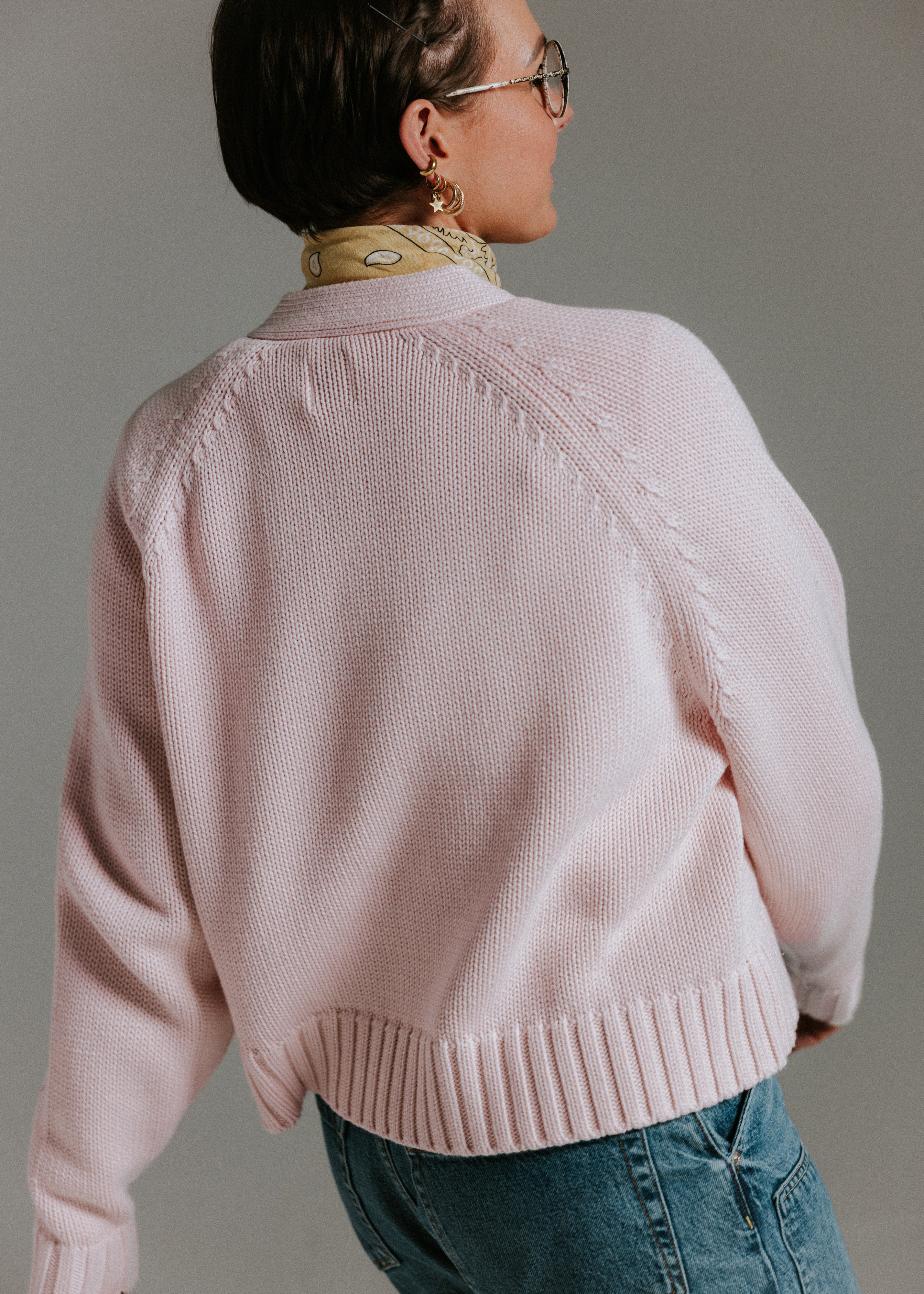 Back view of The Staple Cardigan in mallow with soft cotton knit texture and relaxed shape