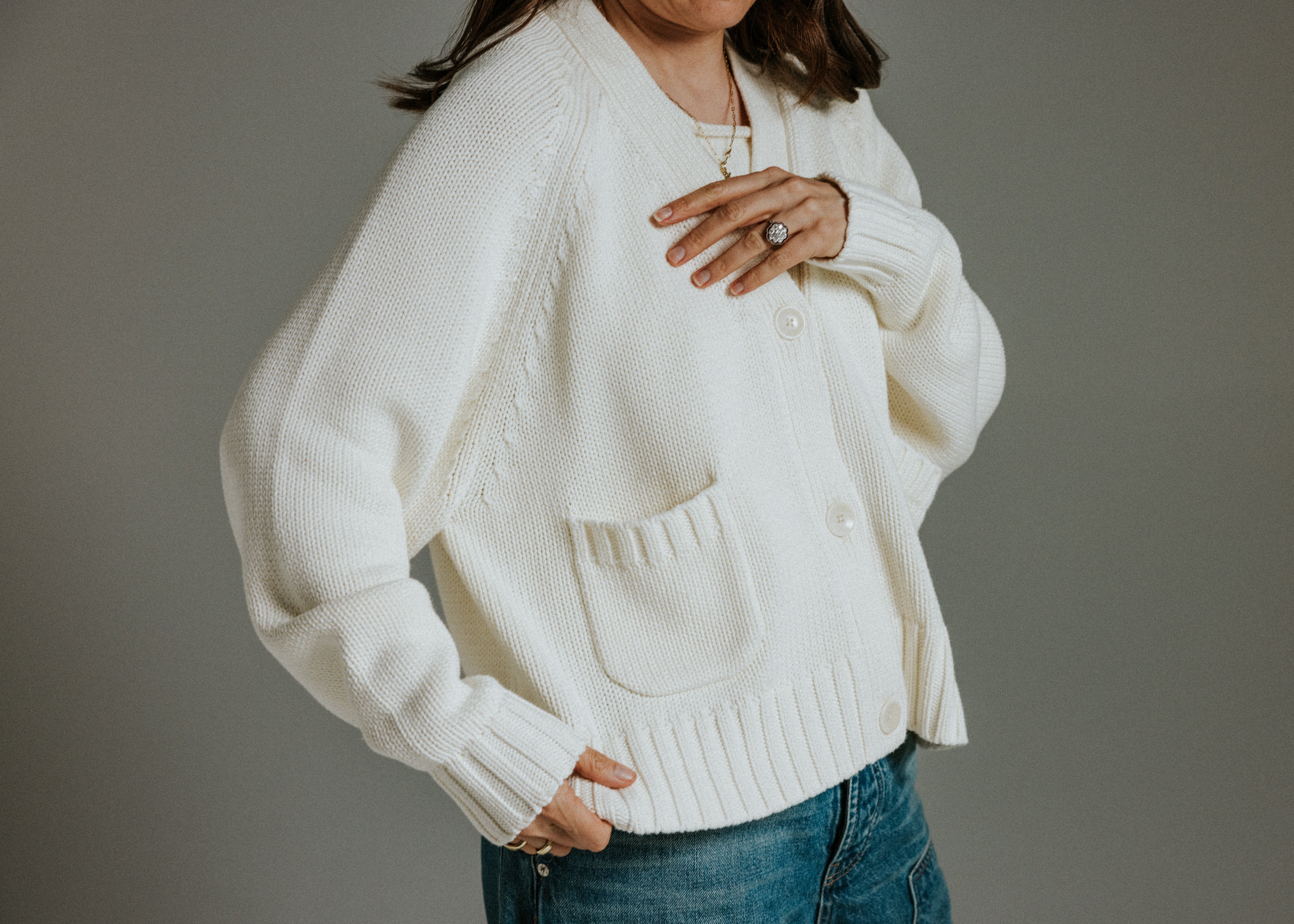 Close-up of premium cotton knit texture on The Staple Cardigan in panna cotta