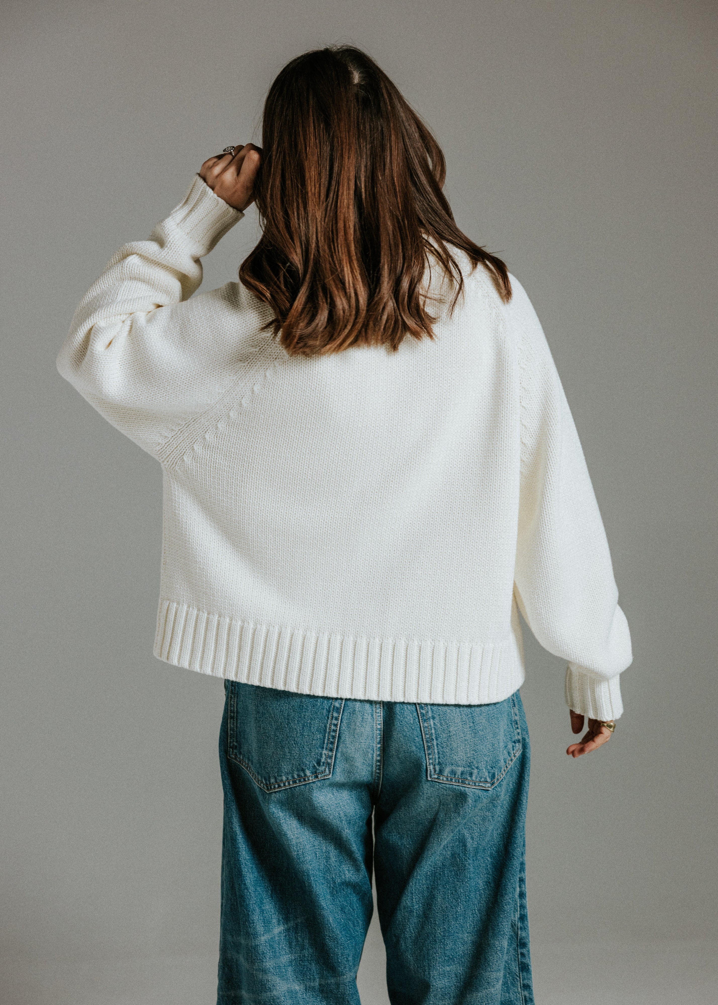 Panna cotta cotton knit cardigan styled with jeans for an effortless everyday outfit