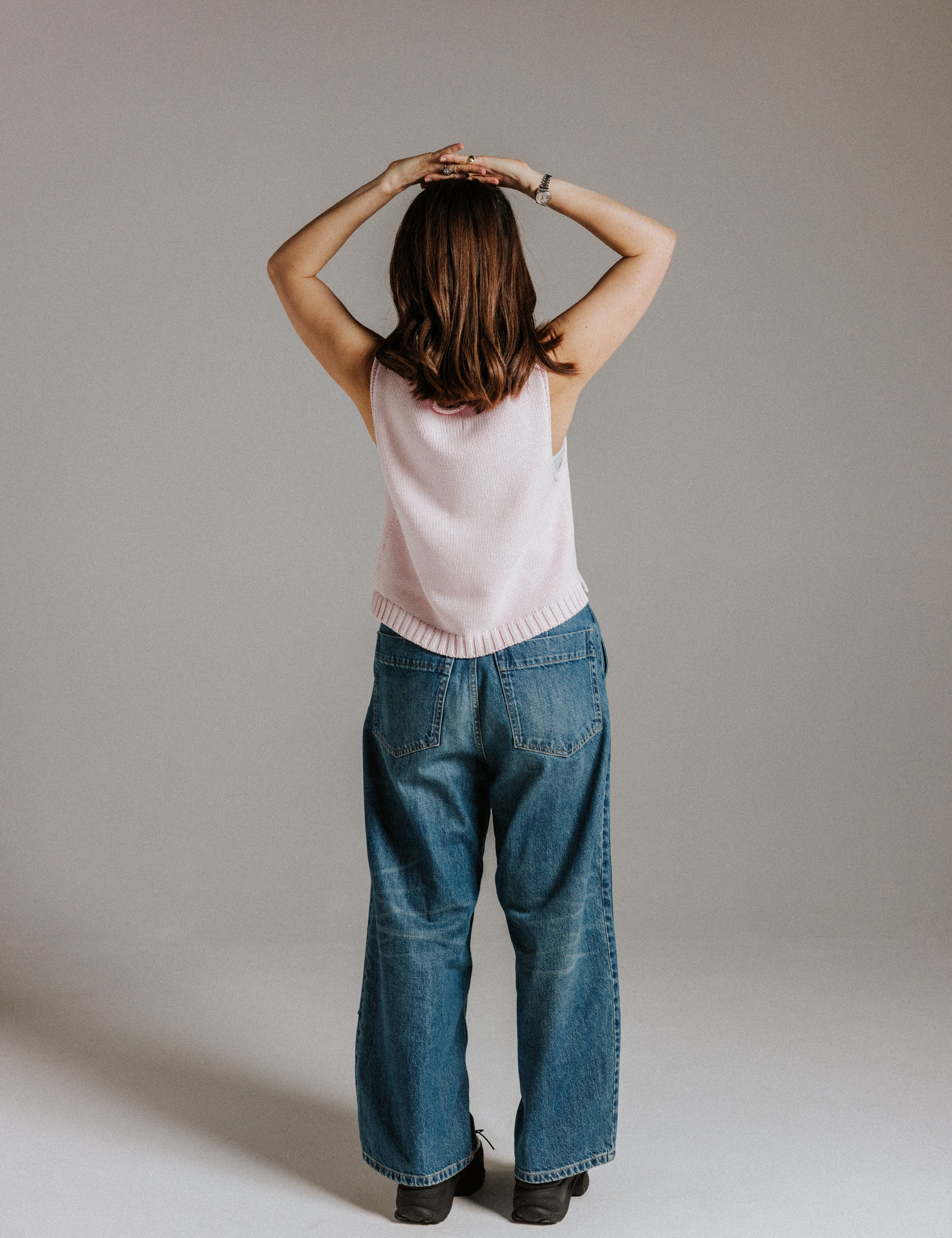 Back view of The Staple Tank in mallow with simple sleeveless design and ribbed hem