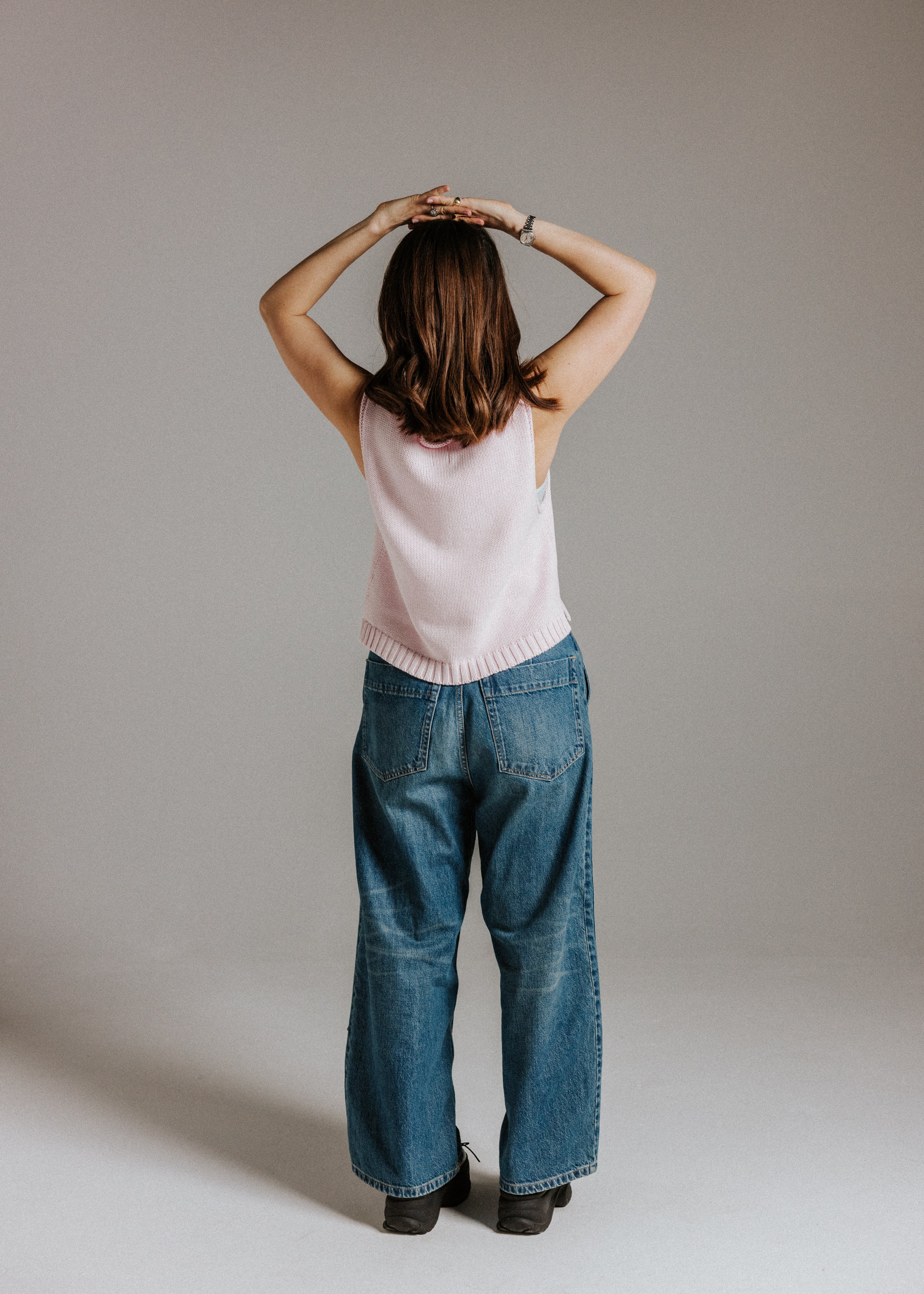 Back view of The Staple Tank in mallow with simple sleeveless design and ribbed hem