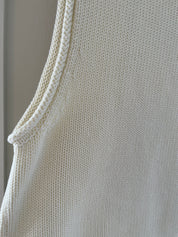 Close-up of armhole and sleeveless cut on panna cotta knit tank top