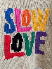 Close-up of Tutti Frutti hand knit jumper showing stitch detail and colourful motif