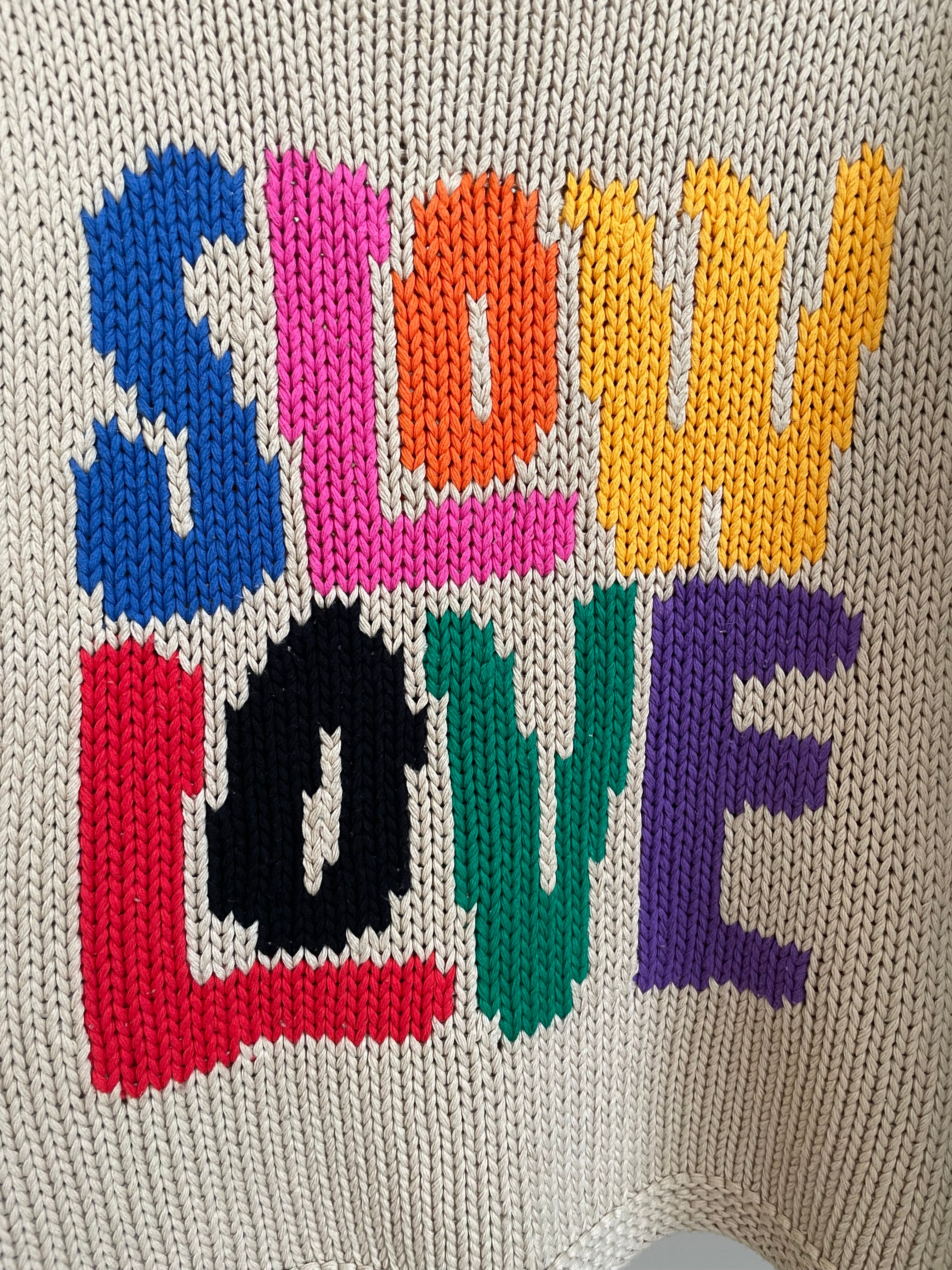 Close-up of Tutti Frutti hand knit jumper showing stitch detail and colourful motif