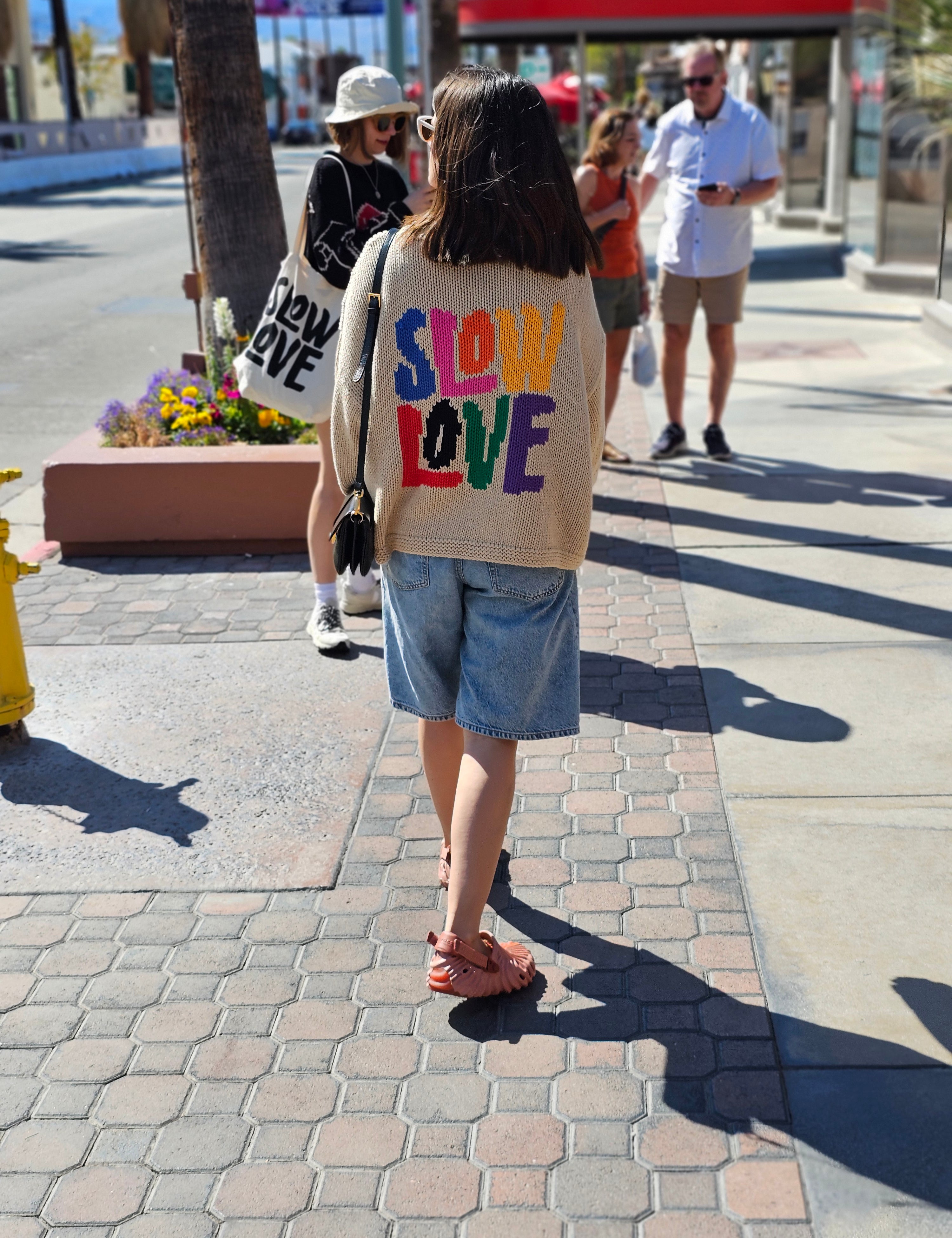 Styled lifestyle image of Tutti Frutti oversized multicoloured hand knit jumper