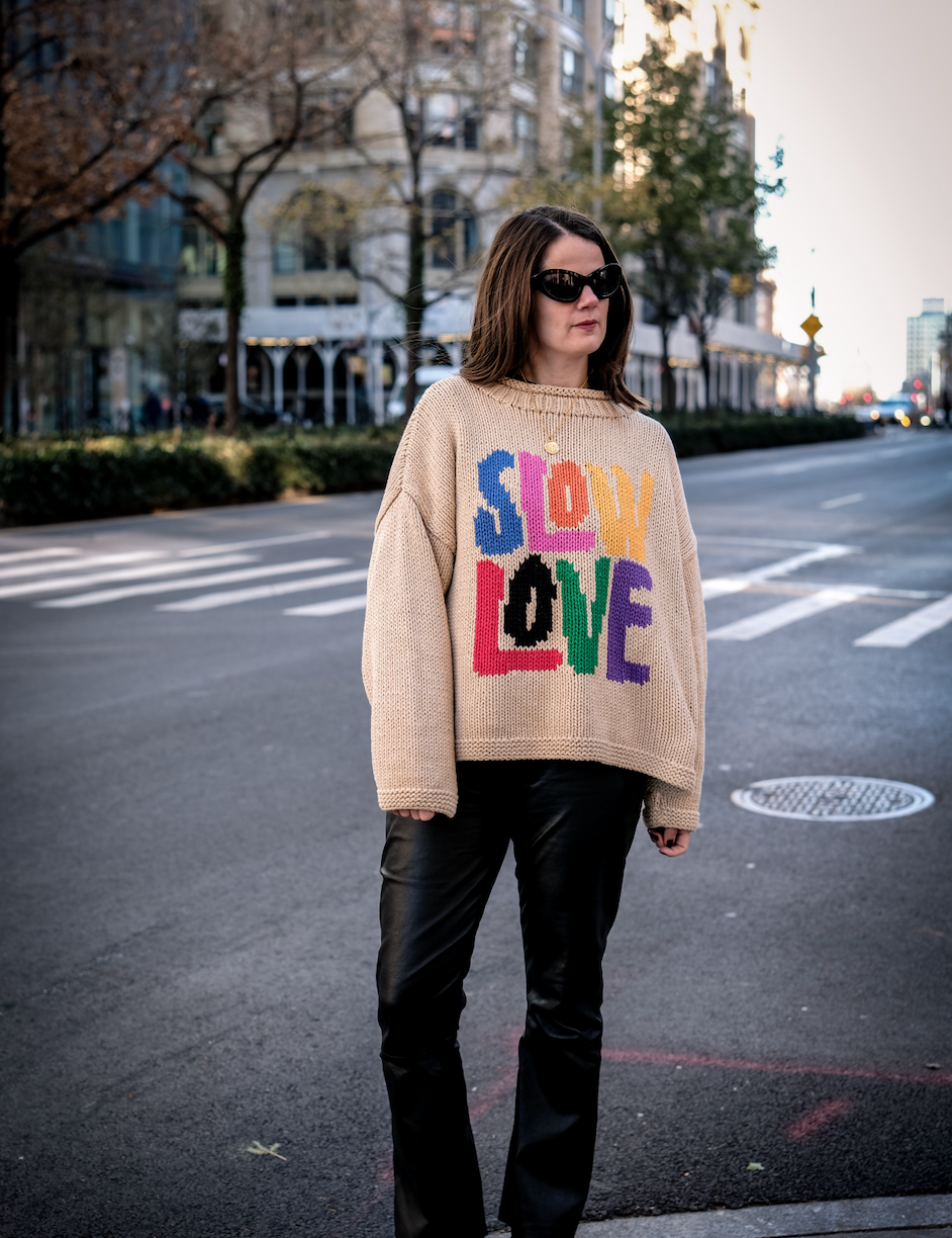 Model wearing Tutti Frutti multicoloured hand knit jumper front view