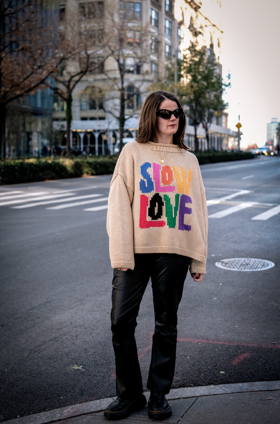 Model wearing Tutti Frutti multicoloured hand knit jumper front view