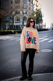 Model wearing Tutti Frutti multicoloured hand knit jumper front view