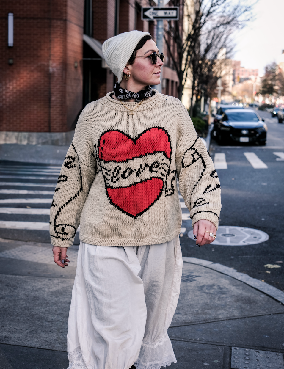 Full length view of ecru hand knitted cotton jumper on model