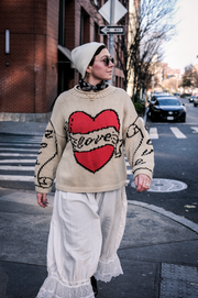 Full length view of ecru hand knitted cotton jumper on model