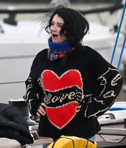 Actress from Bad Sisters wearing black Young Hearts hand knit jumper in lifestyle setting