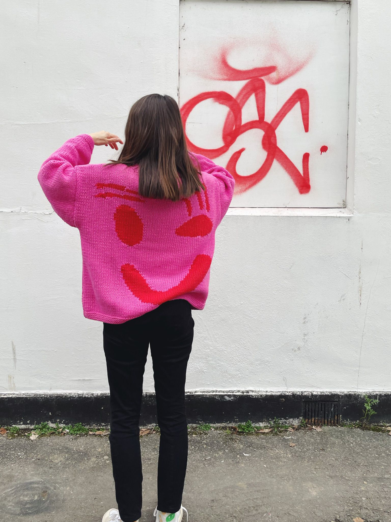 Back view of oversized pink and red hand knitted cotton jumper