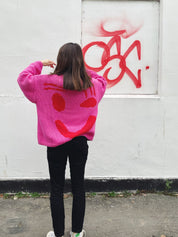 Back view of oversized pink and red hand knitted cotton jumper