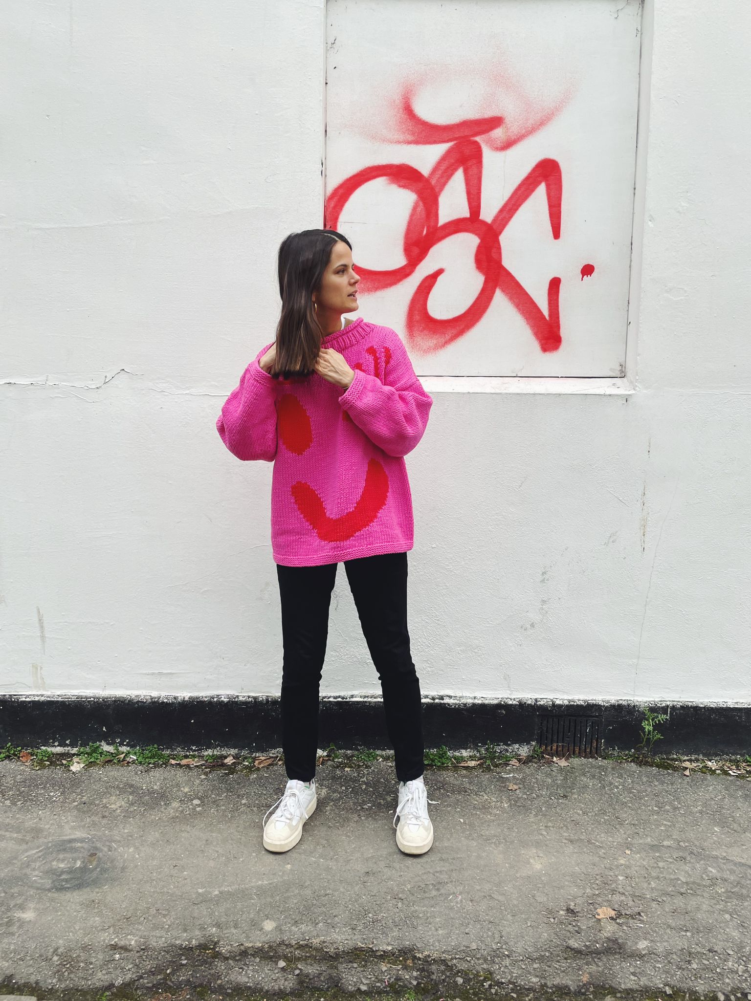 Lifestyle image of pink and red hand knit jumper in slow fashion styling