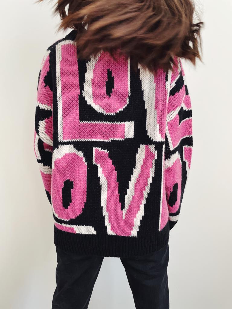 The back of the Slow Love pink Wild Love wool sweater designed with a chunky, warm knit for the winter months.