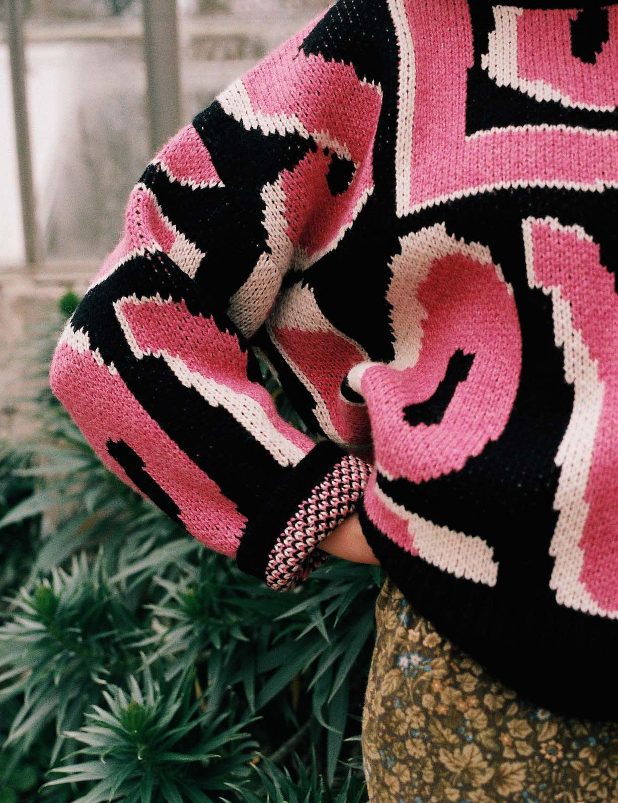 Pink Wild Love jumper by Slow Love showcasing its distinctive birdseye jacquard knit pattern.
